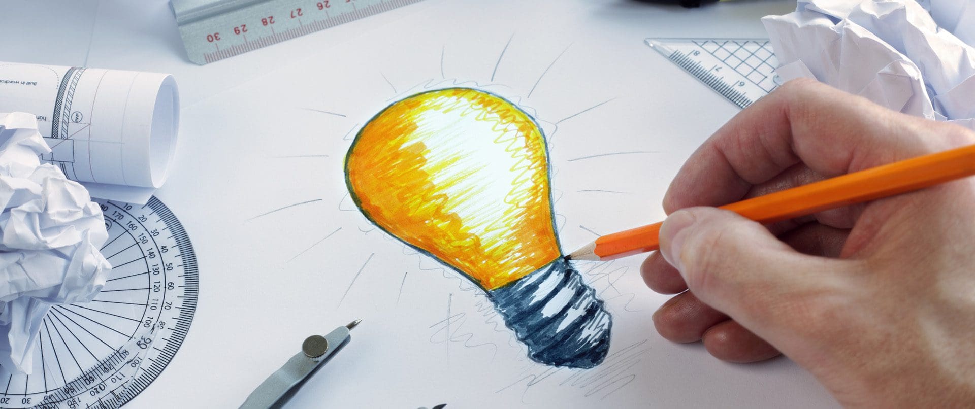 Designer drawing a light bulb, concept for brainstorming and inspiration